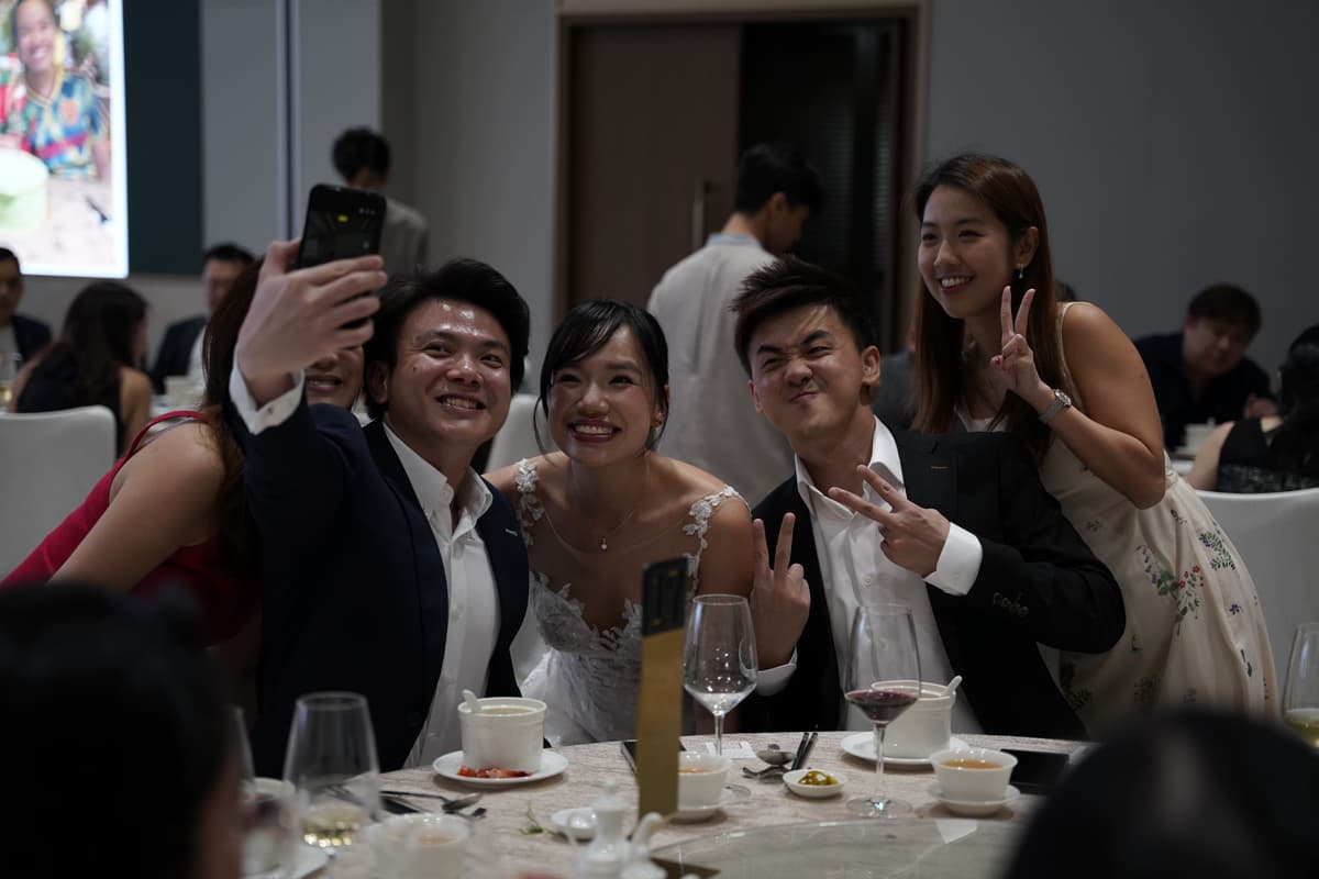 Bride and guests taking a wedding selfie together